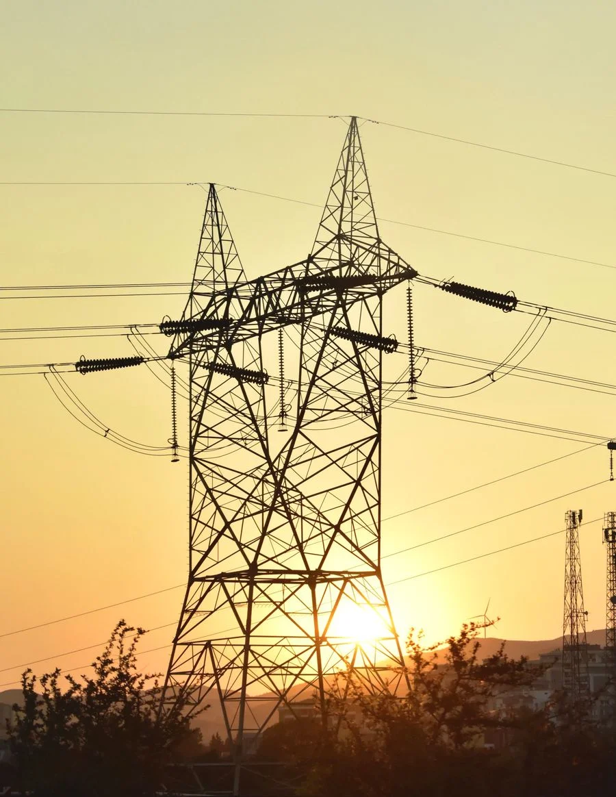 High-voltage power lines at dusk